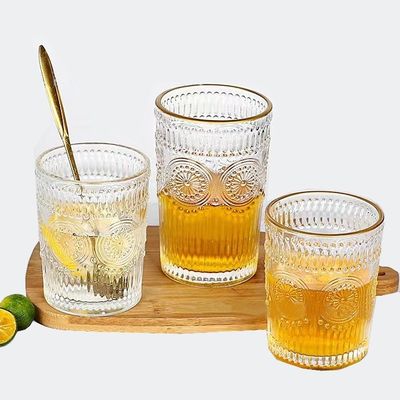 OEM creativo retro embossed girasol whisky jugo de leche tumbler copa de agua de vidrio resistente al calor